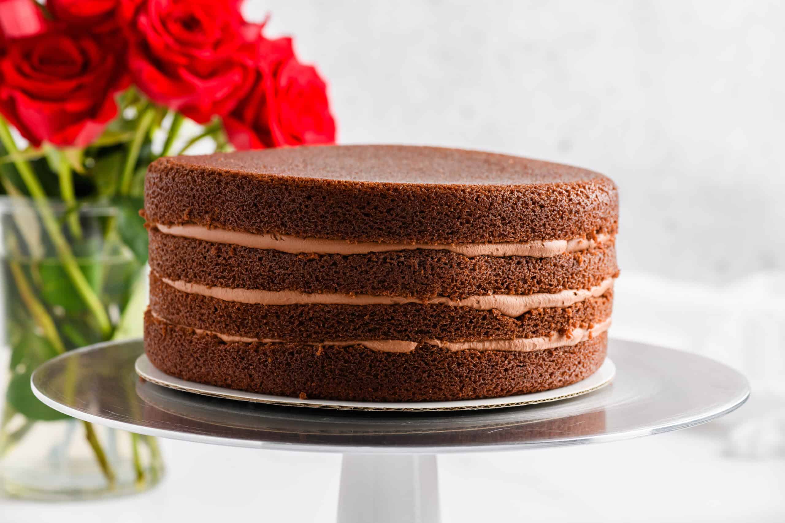 Filled and stacked Chocolate Raspberry Cake with Whipped Ganache Frosting process.