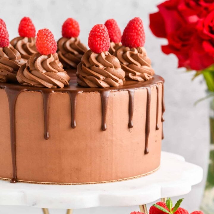 Chocolate raspberry cake with whipped ganache frosting and chocolate drip