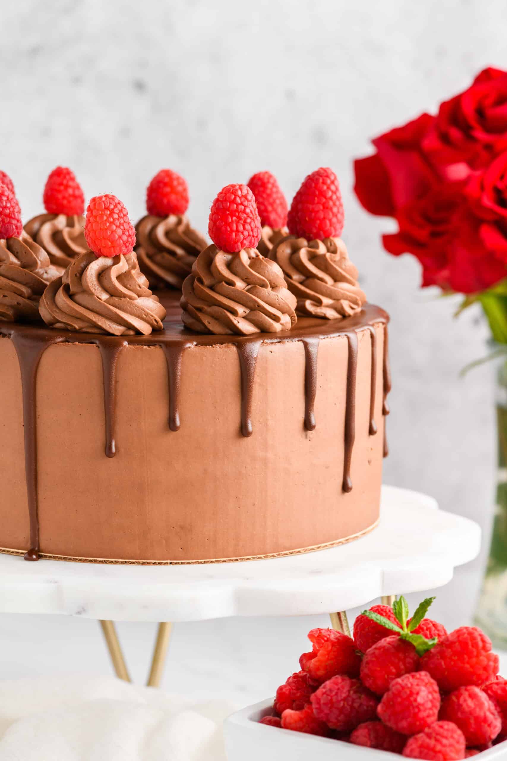 Chocolate raspberry cake with whipped ganache frosting and chocolate drip