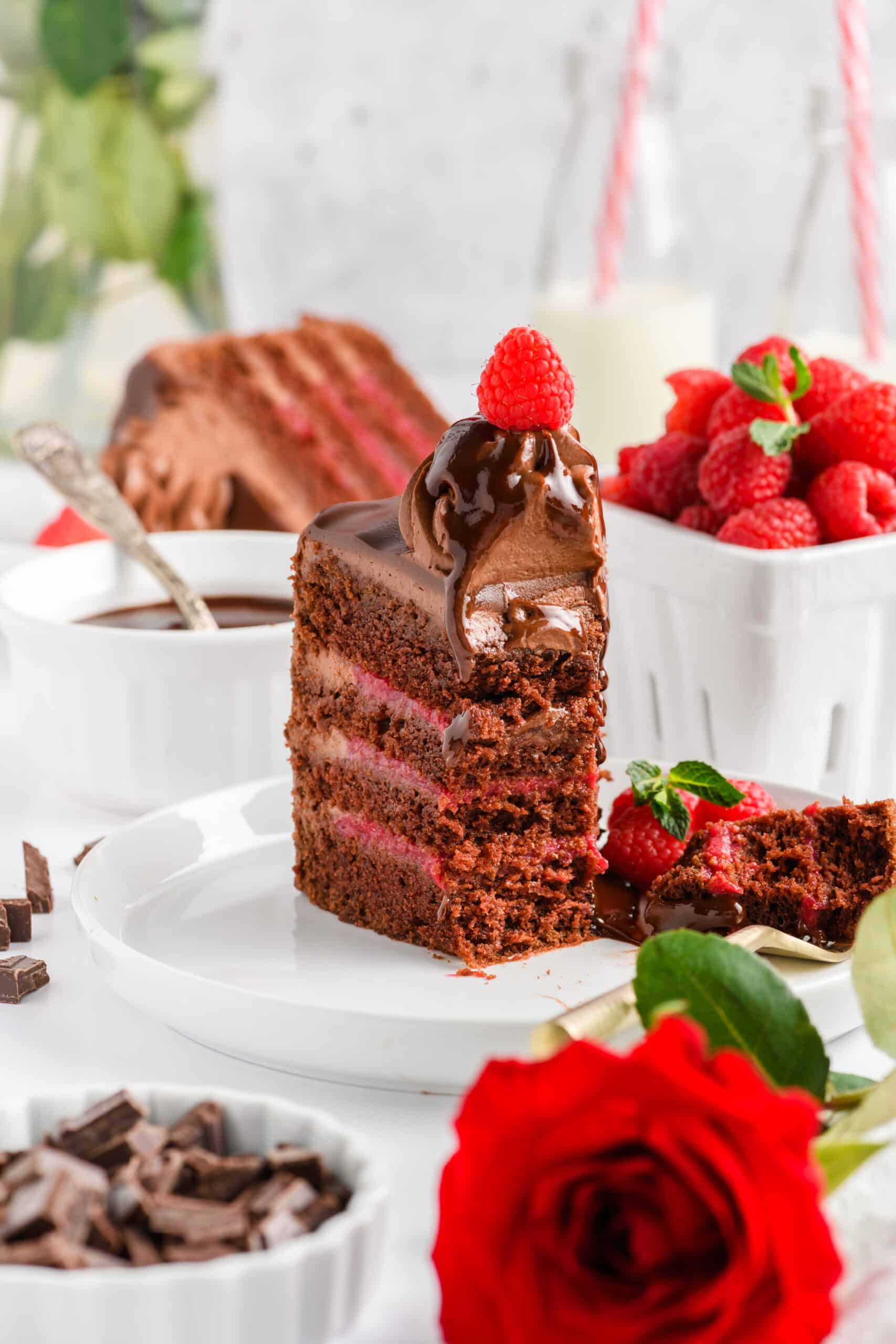 Chocolate Raspberry Cake with Whipped Ganache Frosting slice with chocolate sauce.