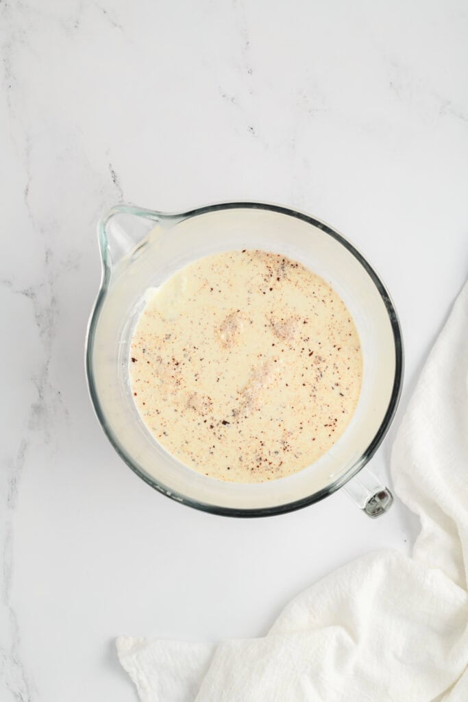 Overhead shot of combined ingredients for whipped ganache for Chocolate Raspberry Cake.