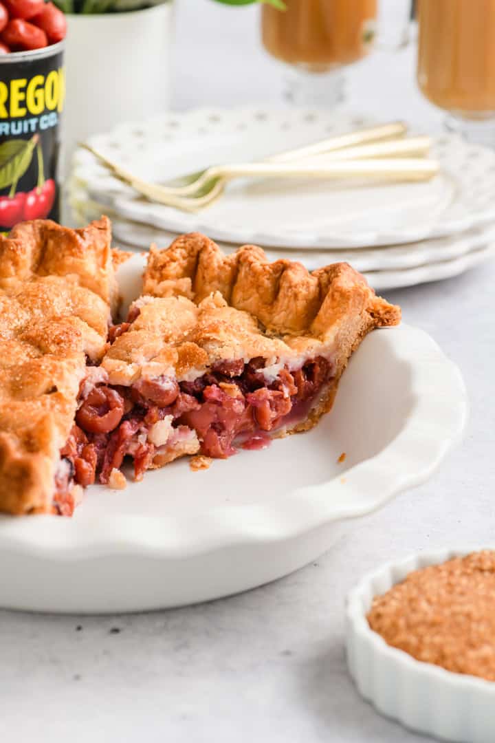 Angled image of cut pie in dish showing texture of Easy Cherry Pie.