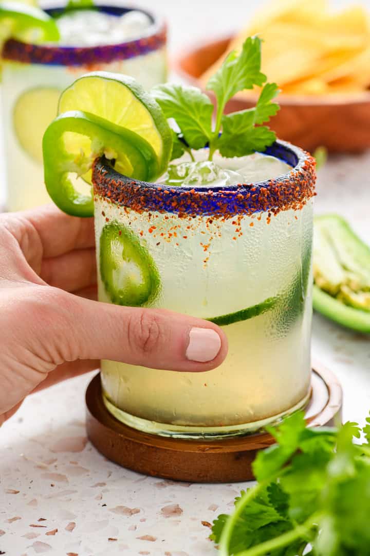 Jalapeno Margarita served with hand grabbing glass.
