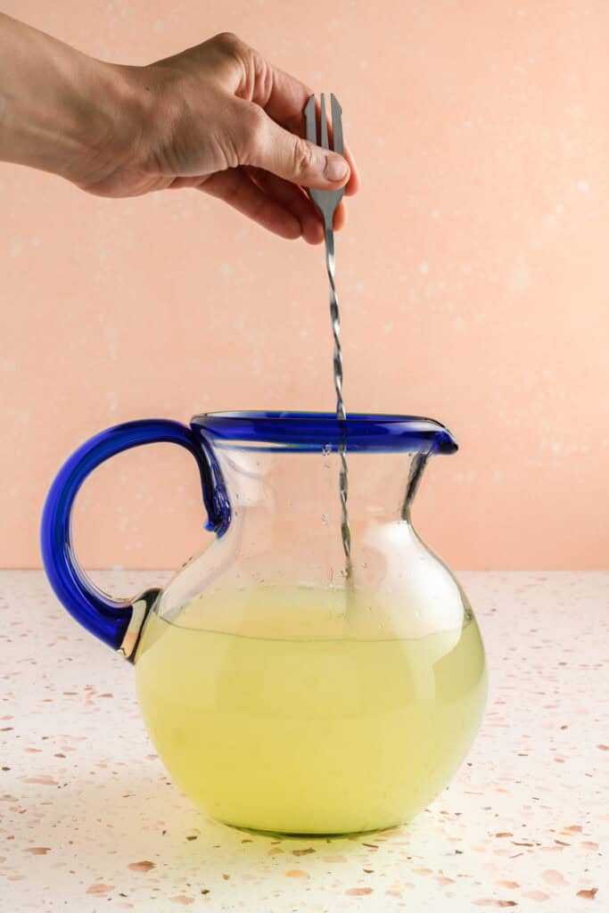 Process shot stirring Jalapeño Margaritas ingredients together.