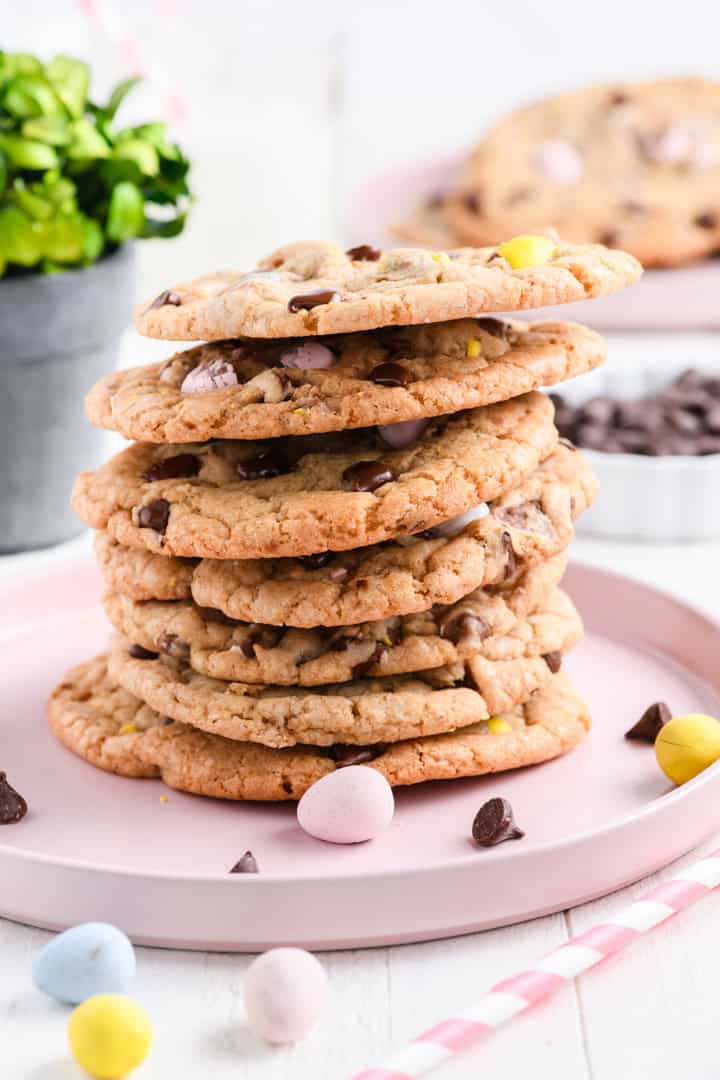 Head on shot of tall stack of Easy Easter Chocolate Chip Cookies on pink plate.