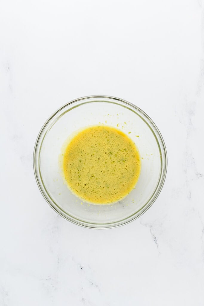 Overhead shot of egg yolk and lime zest mixture for Key Lime Pie.