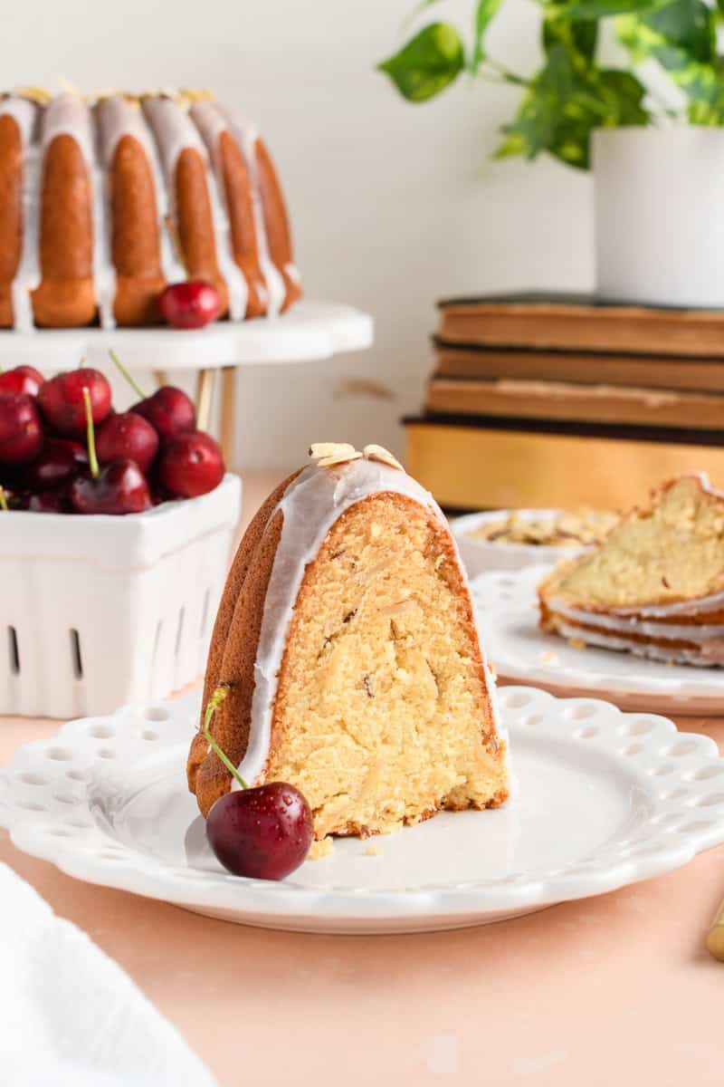 Sliced Amaretto Bundt Cake standing on white plate.