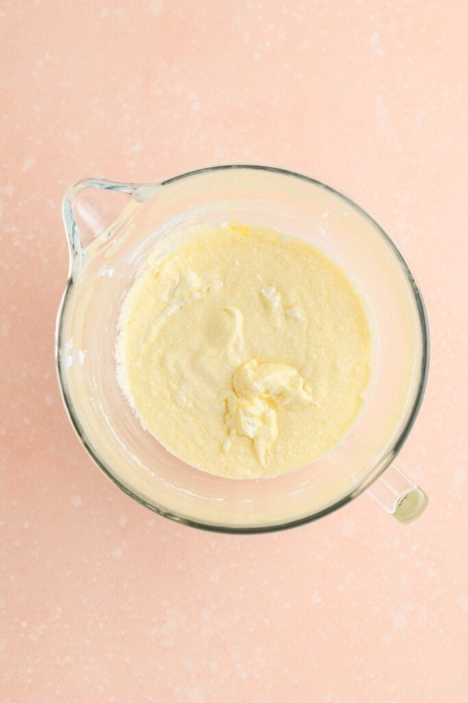 Overhead shot of egg incorporated into creamed mixture for Amaretto Bundt Cake.