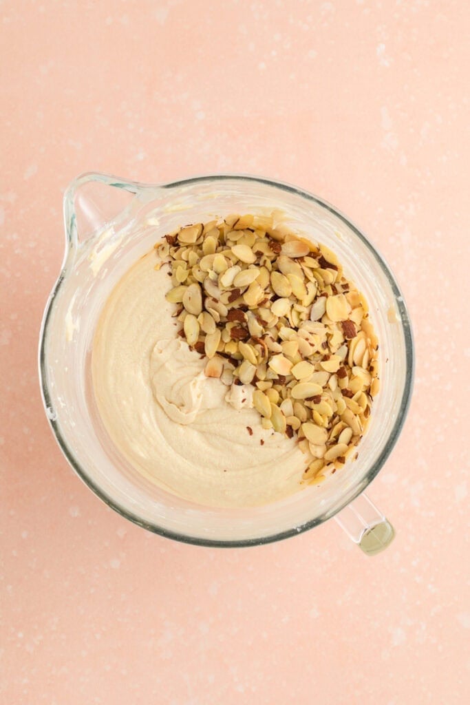 Overhead shot of completed Amaretto Bundt Cake batter with almonds on top.