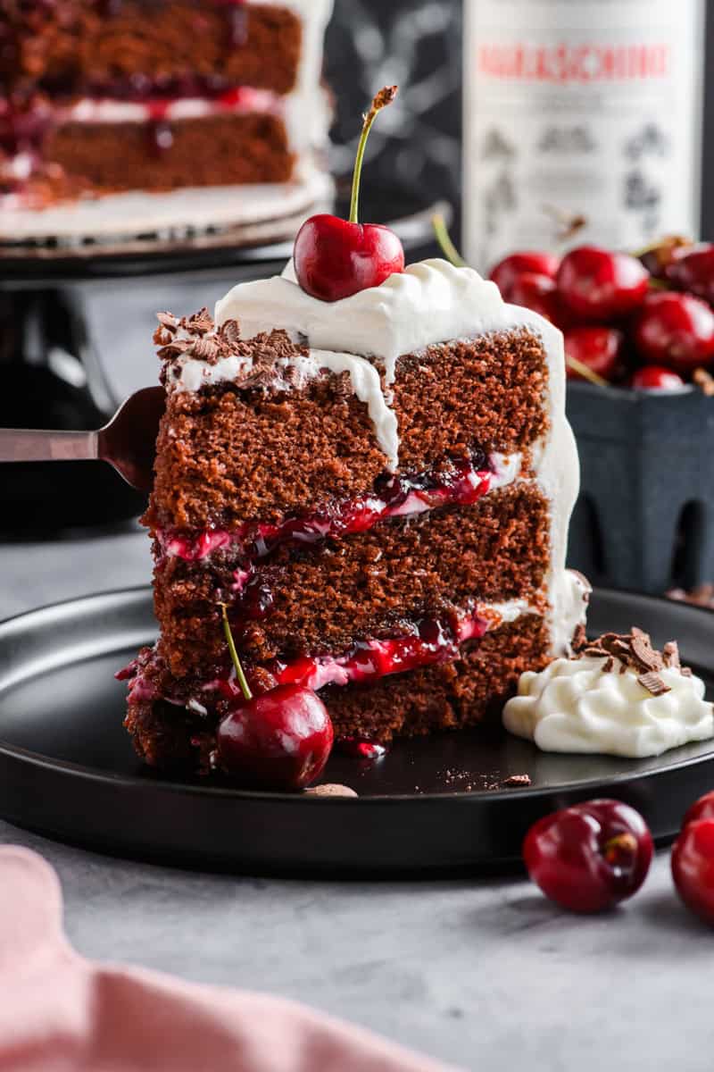 Close up shot of slice of Black Forest Cake being sliced with a fork.