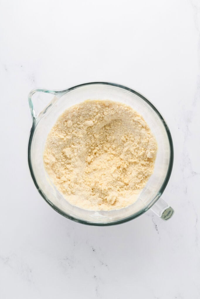 Overhead shot of the dry ingredients combined with butter for Funfetti Sheet Cake.