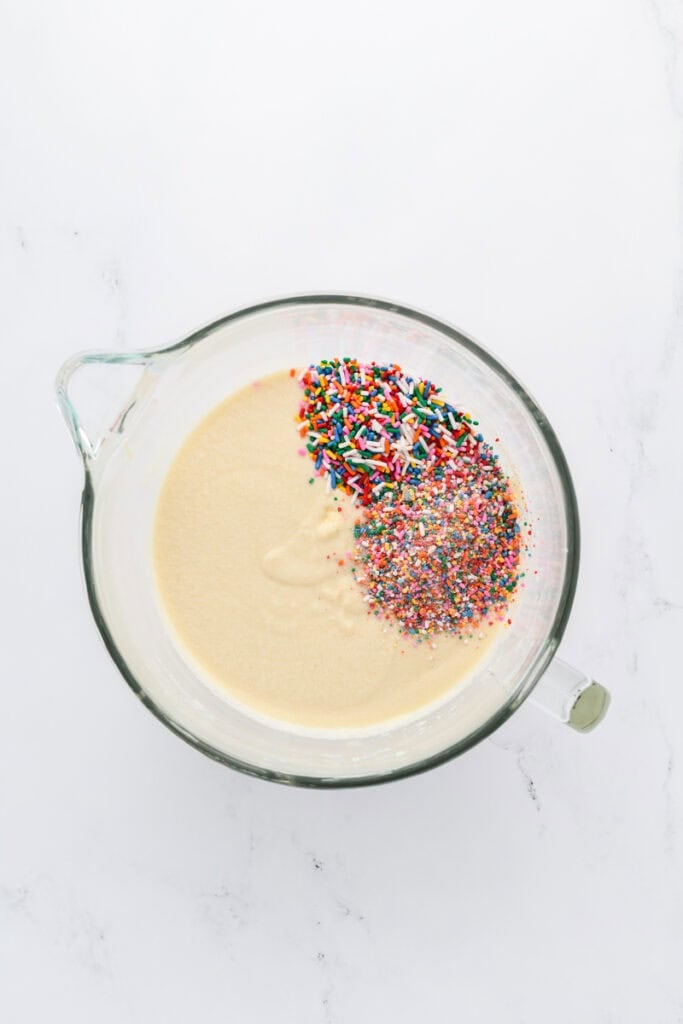 Overhead shot of completed Funfetti Sheet Cake batter with sprinkles tossed in.