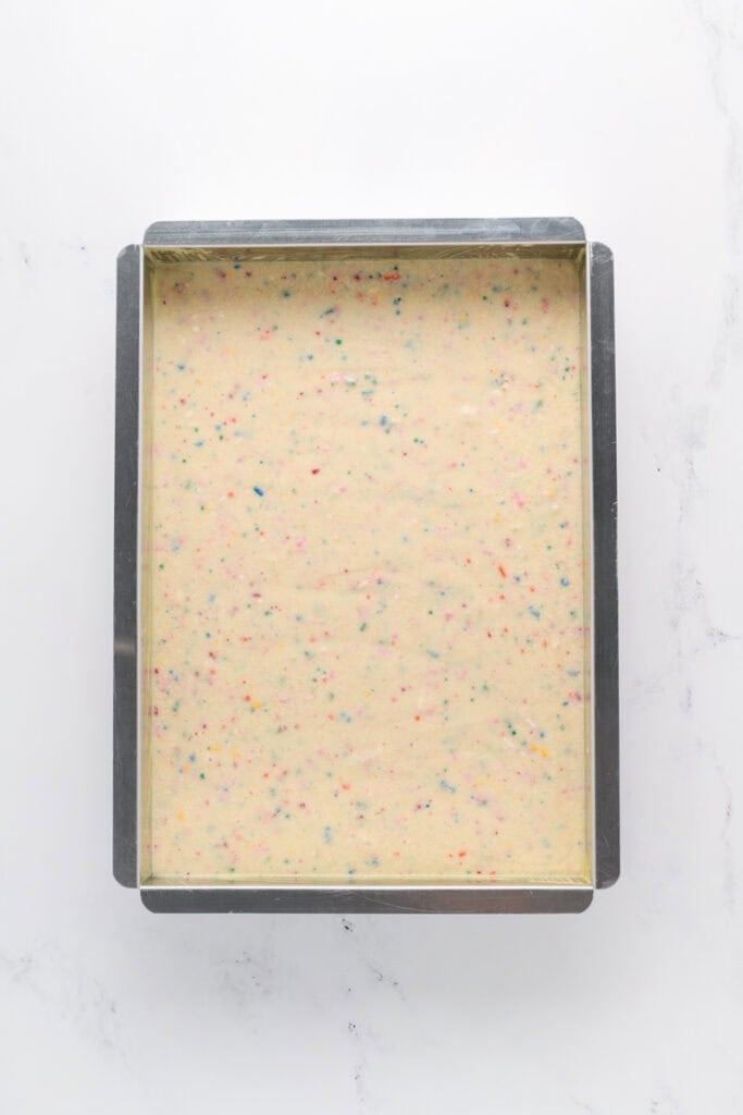 Overhead shot of Funfetti Sheet Cake batter in baking pan.