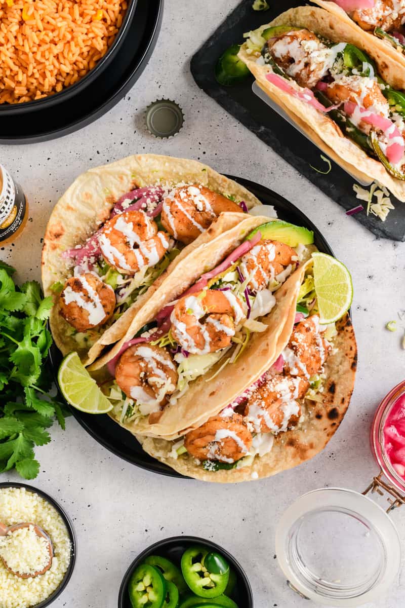 Overhead shot of Easy Shrimp Tacos on black plate.
