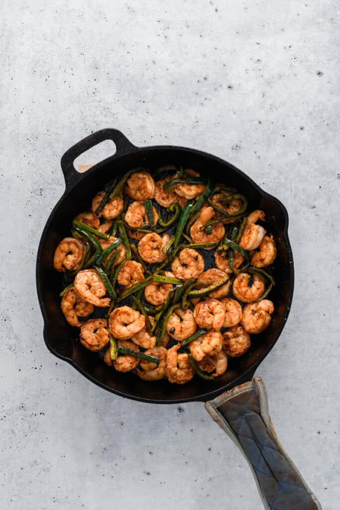 Overhead shot of cooked peppers and shrimp for Easy Shrimp Tacos.