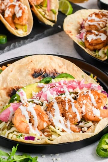 Easy Shrimp Tacos on black plate.