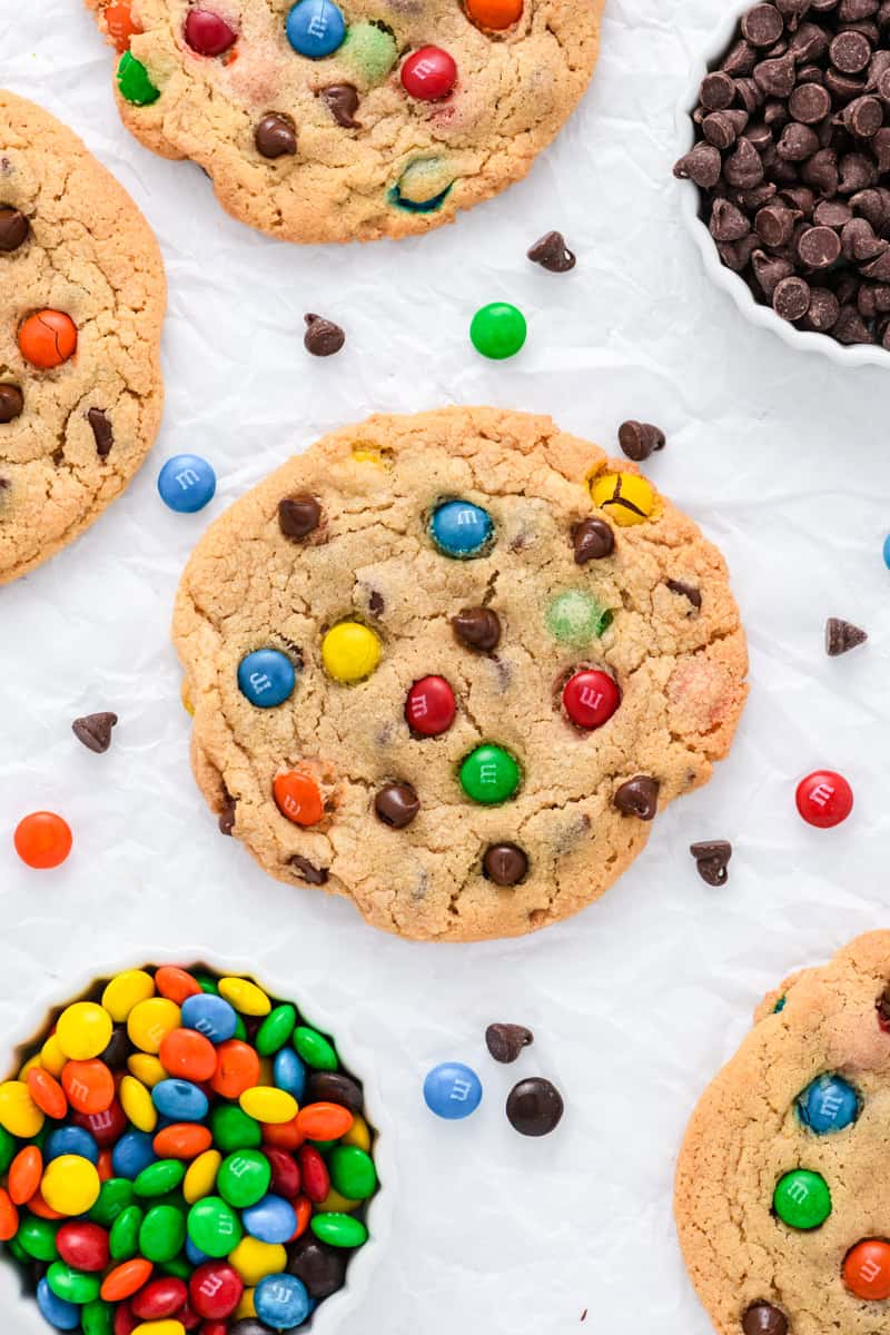Overhead close up of single Best Big Fat Chewy Chocolate Chip M&M Cookie on wrinkled parchment paper.