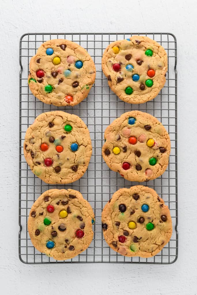 Overhead shot of baked Best Big Fat Chewy Chocolate Chip Cookies cooling on a cooling rack.