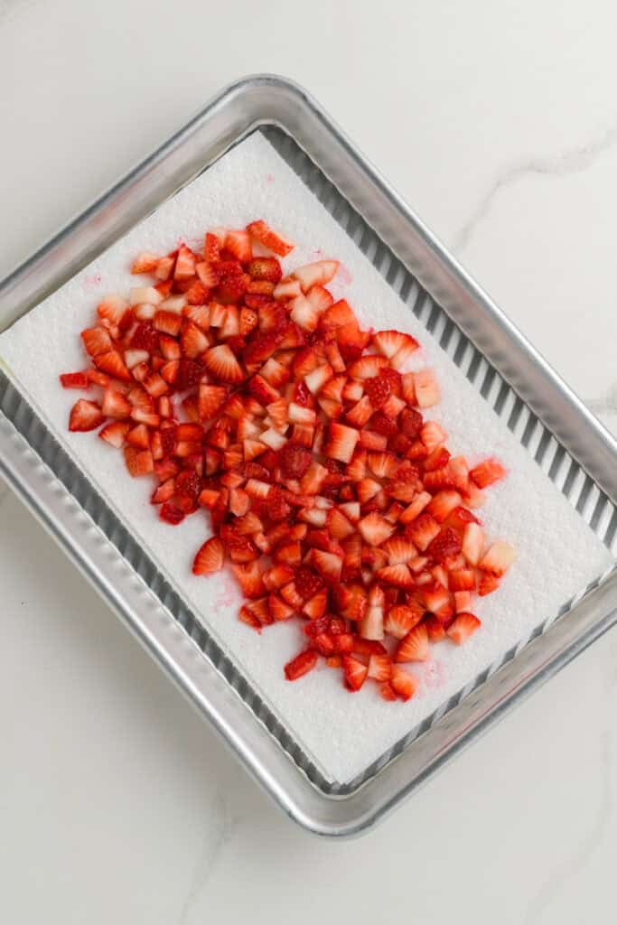 Overhead shot of strawberries sitting on paper towels for Homemade Strawberry Muffins.