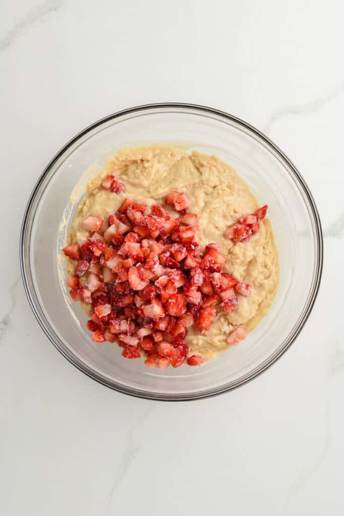 Overhead shot of Homemade Strawberry Muffins batter with strawberries.