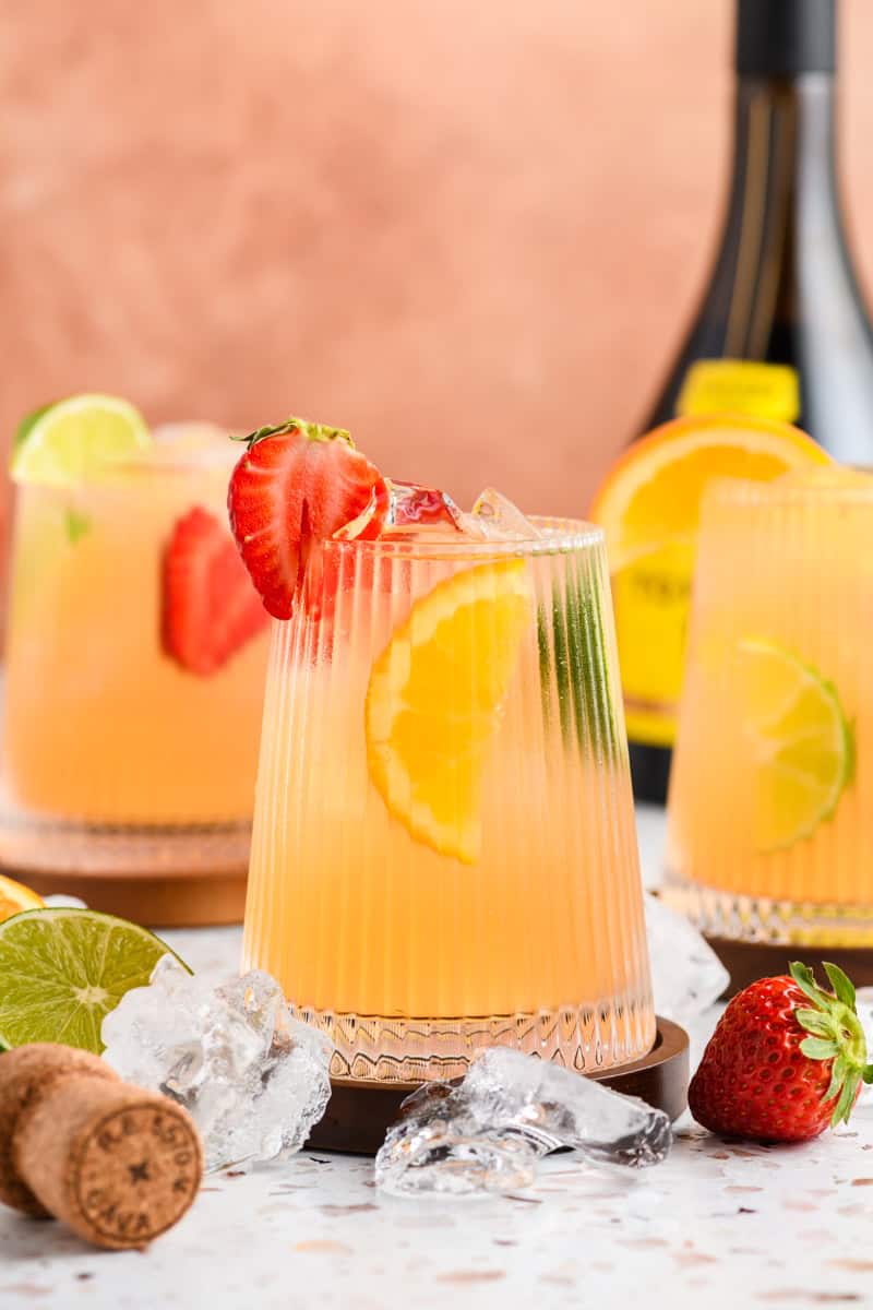 Glass of Sparkling Sangria with 2 glasses and Spanish brandy in the background.