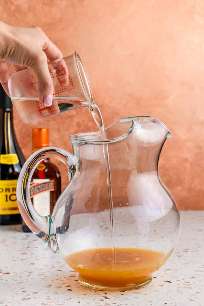 Process shot for Sparkling Sangria with simple syrup going in.