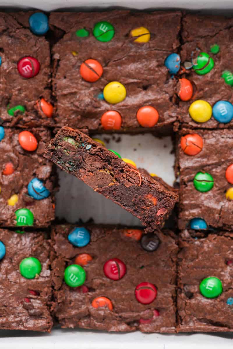 Close up overhead shot of side of M&M Brownies in baking pan.