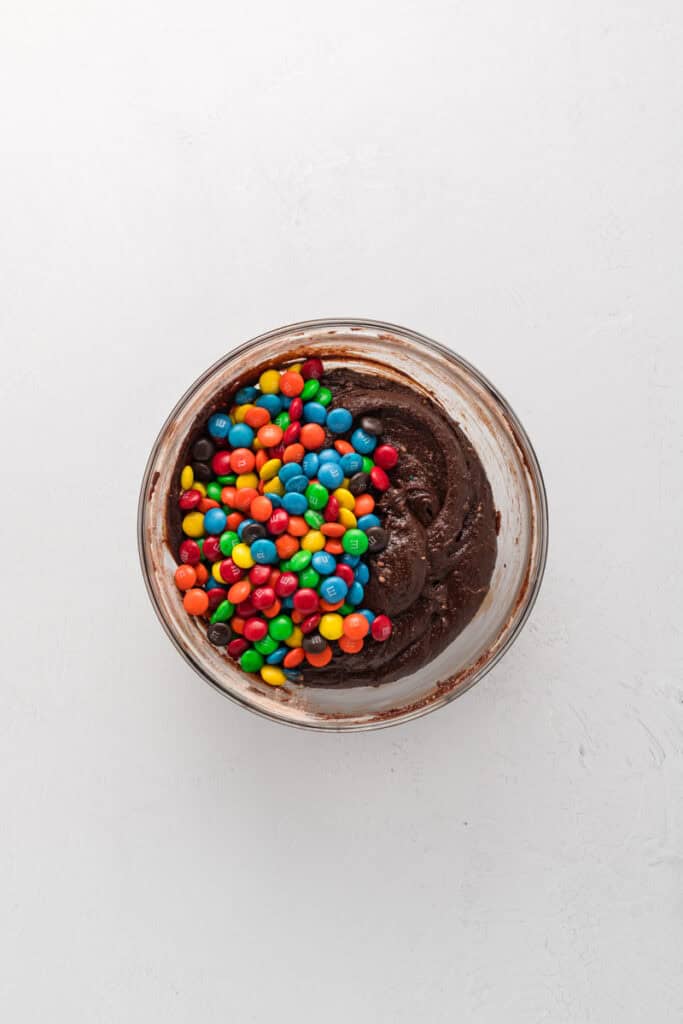 Overhead shot of M&M Brownie batter with M&M's added.