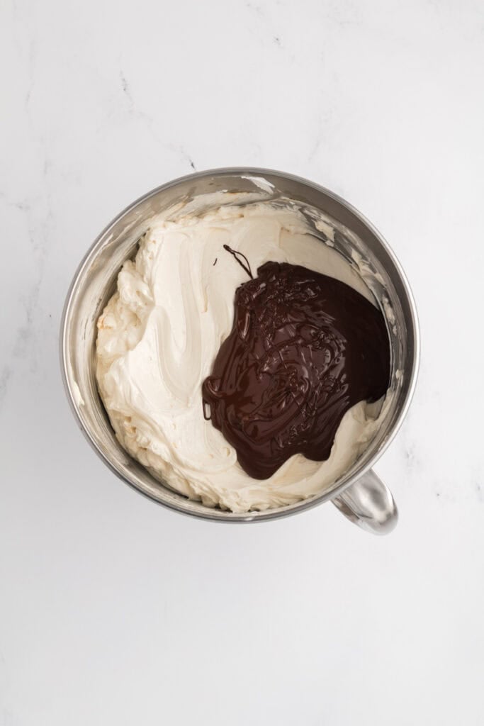 Overhead shot of Swiss meringue buttercream with chocolate added for M&M Chocolate Cake.